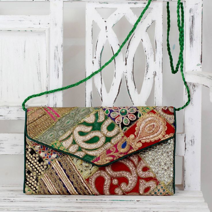 Embroidered and embellished with sequins this chic shoulder bag is crafted by hand. A vibrant patchwork of recycled fabrics brings bright color to this original design. From Vipin in India the handbag opens to reveal a zipper pocket and hangs from a green strap. Because the available recycled fabrics will vary no two bags are ever identical. Each one is a handcrafted example of textile art. The basic theme and colors will be very similar. Upcycled Handbag, Patchwork Purse, India Gift, Metallic Yarn, Womens Fashion Edgy, Free Gift Wrapping, Recycled Fabric, Diy Bag, Fashion Styles