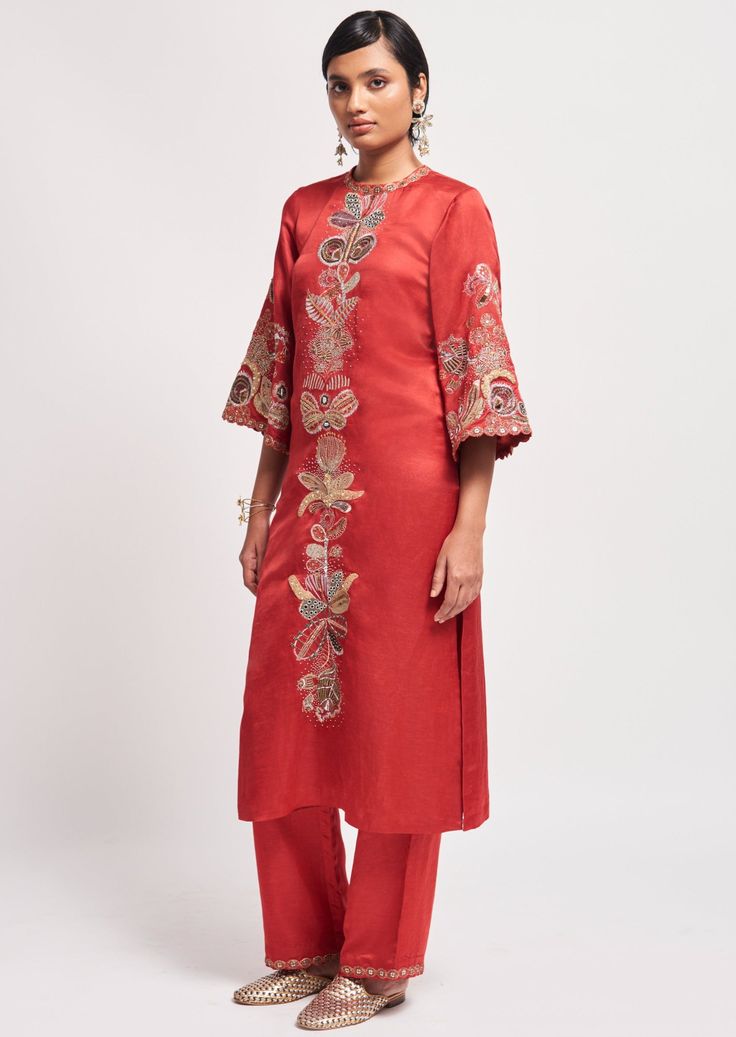 Rust red applique embellised linen satin straight kurta, pant & tulle dupatta. Red Embroidered Slub Silk Kurta, Red Silk Kurta With Resham Embroidery, Embroidered Chanderi Pant Set, Festive Embroidered Tissue Silk Palazzo Set, Designer Festive Pant Set With Floral Embroidery, Red Embroidered Cotton Silk Sharara, Silk Pant Set With Straight Kurta And Floral Embroidery, Elegant Cotton Silk Sharara For Celebration, Red Embroidered Palazzo Set For Diwali