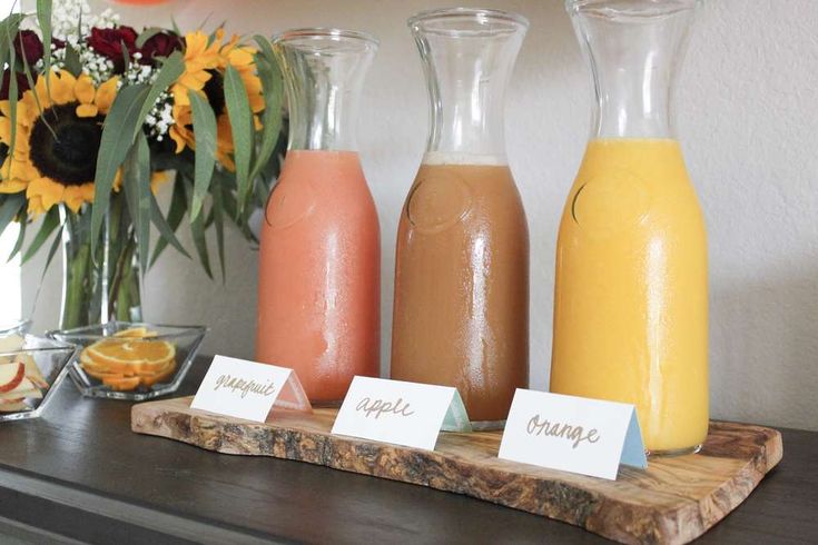 there are three different types of juices on the table with name tags in front of them