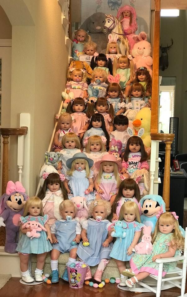 a group of dolls sitting on top of a stair case