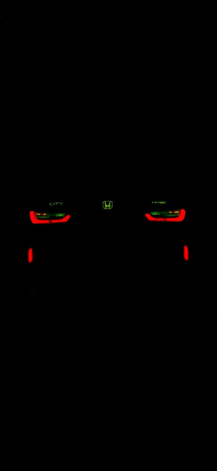 two cars are shown in the dark with their headlights turned red and one is green