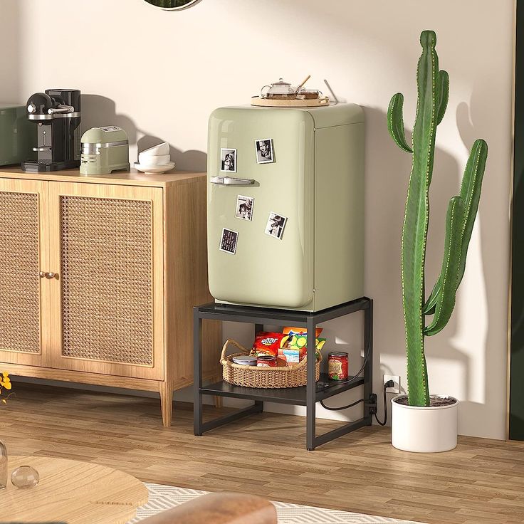 a green refrigerator sitting next to a cactus in a living room