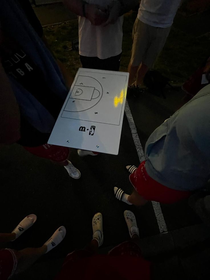 a group of people standing around a white frisbee