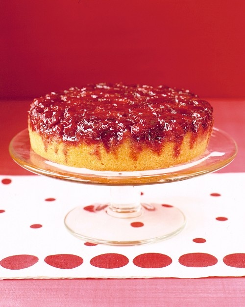 a cake sitting on top of a glass plate next to a polka dot table cloth