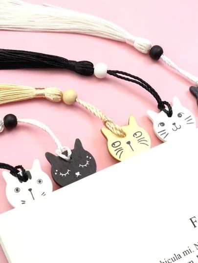 the bookmarks are decorated with cats and tassels on it's sides