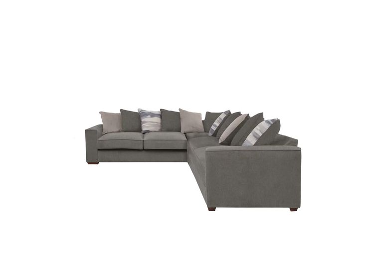 a gray sectional couch with pillows on it's back and side facing each other