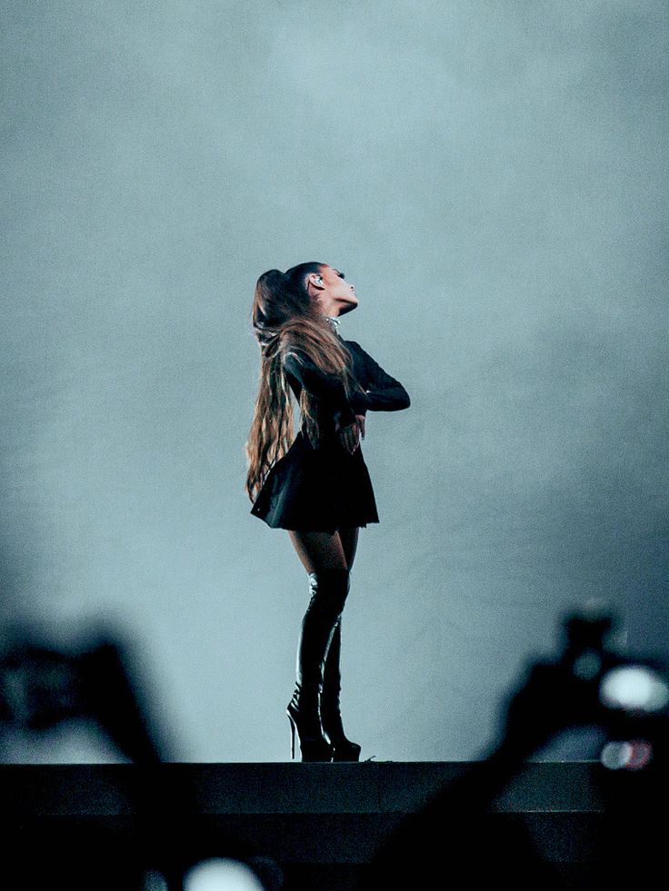 a woman standing on top of a stage holding a microphone