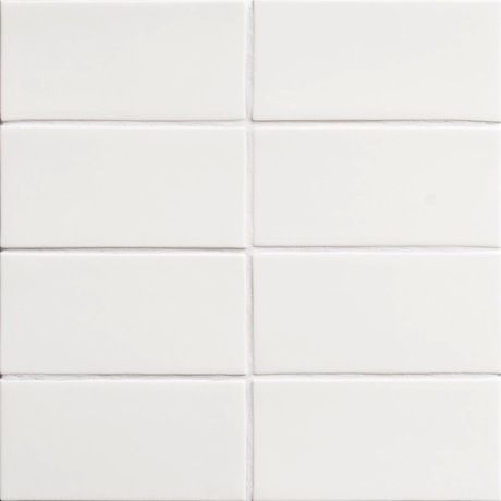 a white tile wall that is very close to the ground with no one on it