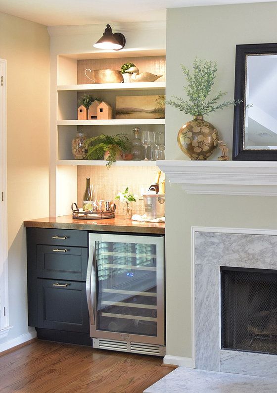 a kitchen with a fireplace and built - in shelving