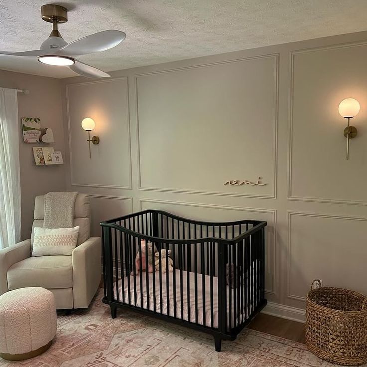 a baby's room with a crib and chair