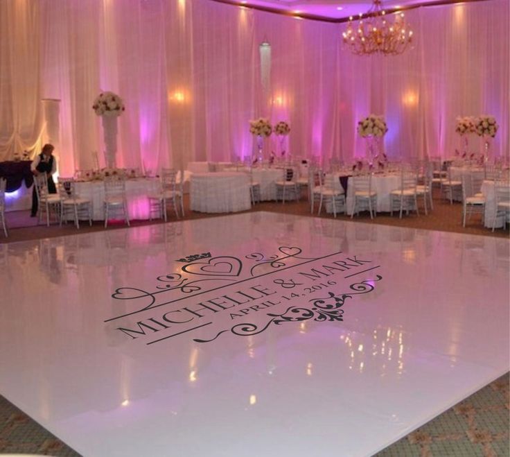 the dance floor is decorated with white chairs and chandeliers