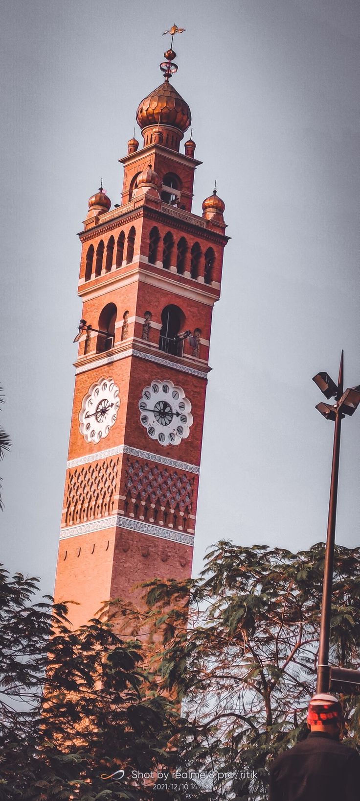 a tall clock tower with clocks on each of it's sides