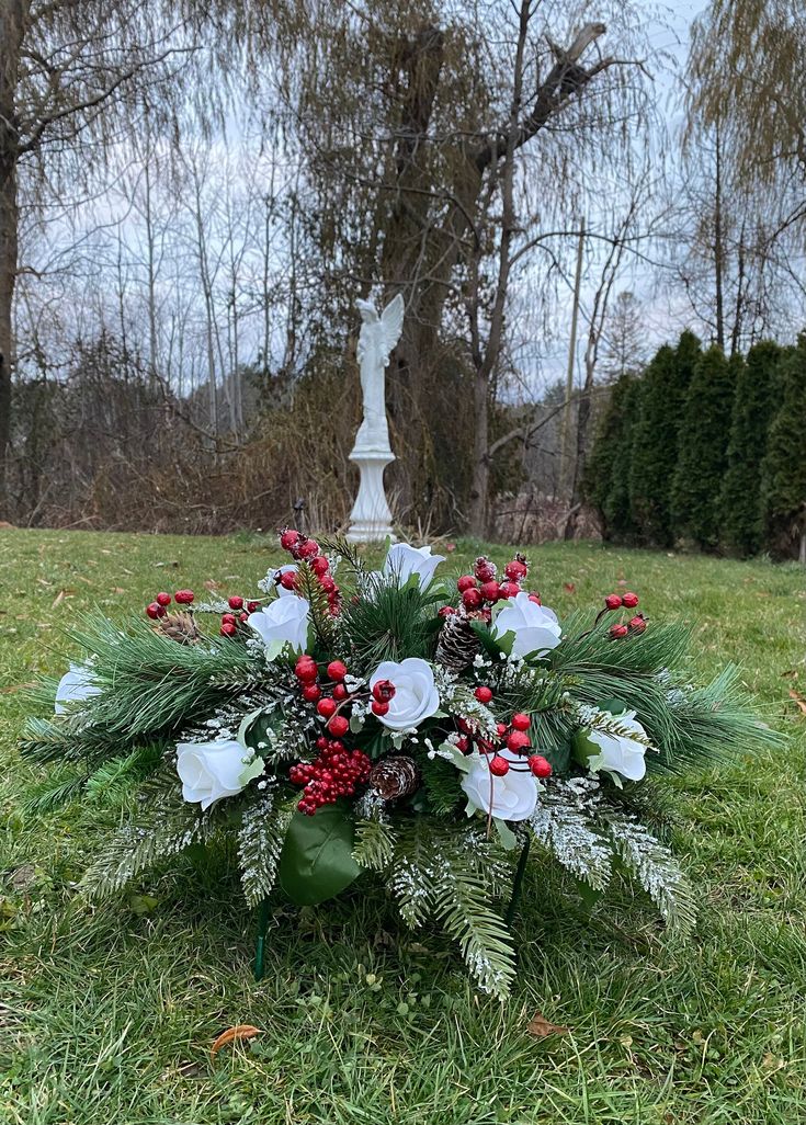 This Berries Christmas Saddle is part of the CHRISTMAS Collection. Beautiful We are a small Family business designing and making floral arrangements for all occasions for over 30 years.  All items are carefully custom made and handcrafted with Love.  We are happy to bring you unique design and creation from Heart to Heart Berries Christmas Saddle: This medium Saddle consists of pine cones, roses, berries, and pine frosted with snow. This arrangement is set in a cradle (saddle wire). Measurement: Approximately 24" length, 8" height (from base of arrangement to highest point), and 12" width (widest part). Please note, this same style item can also be custom made in your desired colors. Please feel free to contact us with any questions.   Our goal is to bring you Quality and Professionalism a Headstone Saddle Arrangements Christmas, Winter Headstone Saddle, Christmas Headstone Arrangements, Christmas Headstone Saddles, Christmas Saddles For Headstones, Christmas Grave Decorations Cemetery, Graveyard Flowers, Saddle Arrangements, Christmas Cemetery Flowers