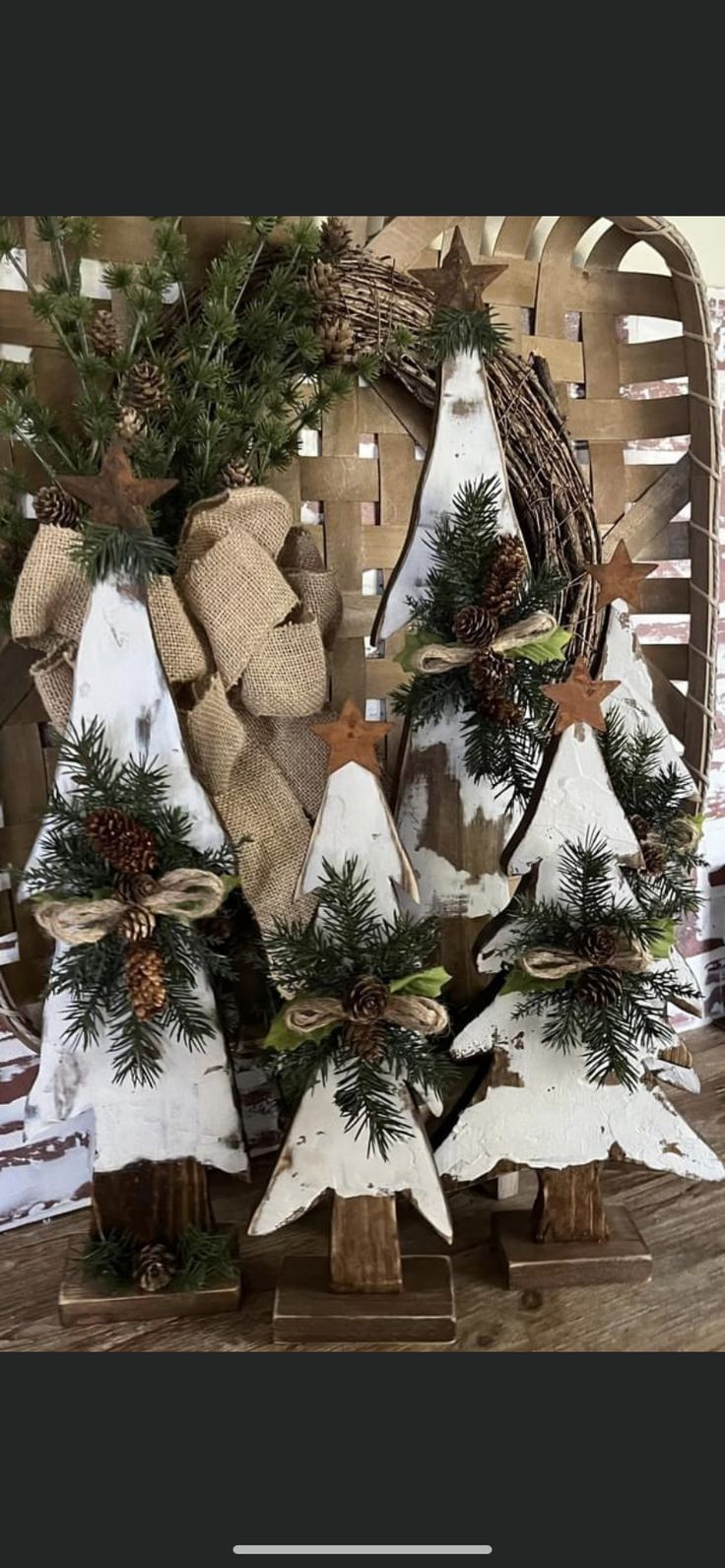 a christmas tree made out of wood with pine cones and burlocks on it