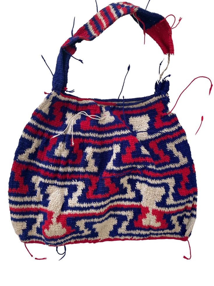 a handbag with red, white and blue designs on the front is being used as an ornament