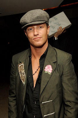 a man in a suit and hat posing for the camera