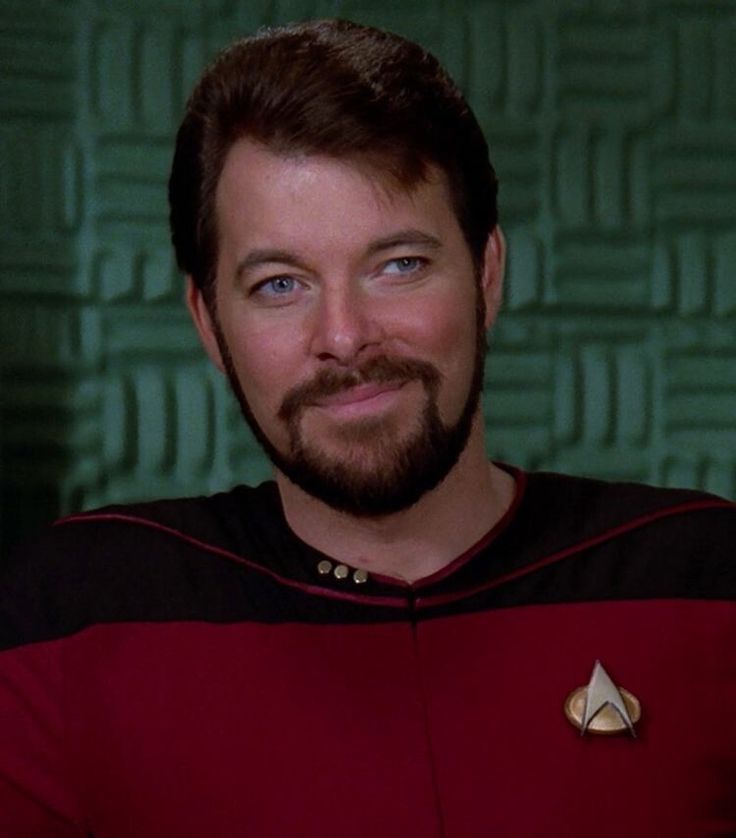 a man with a beard wearing a star trek uniform