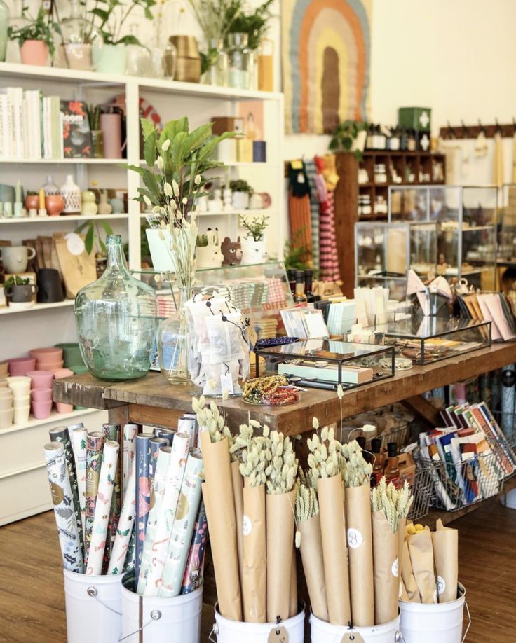 the inside of a flower shop filled with lots of flowers