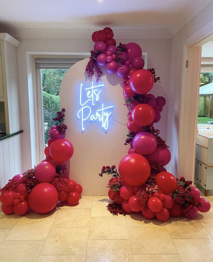 balloons and flowers decorate the entrance to a party