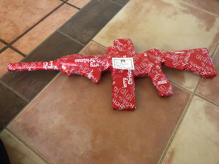 a cross made out of candy wrappers on the floor with words written all over it