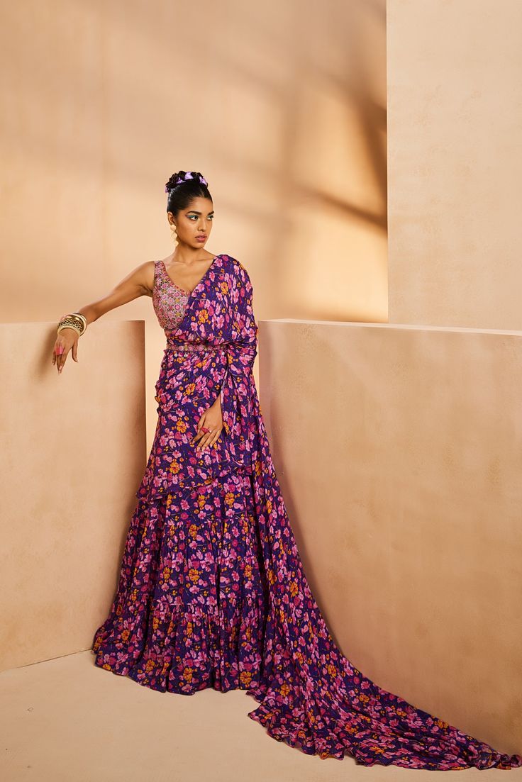 Featuring a floral printed tiered pre-draped sari. It features a very intricately fully hand-embroidered blouse with colorful Japanese bugle beads and sequences. The belt adorned with boho beads accentuates the sari further.From Aneesh Agarwaal's Seher collection.DELIVERY TIMEPlease allow 8-12 weeks for your outfit to arrive.FABRIC DETAILSChinonProfessional cleaning only. Multicolor Floral Print Saree For Reception, Bohemian Georgette Choli For Designer Wear, Bohemian Pre-draped Saree For Festive Designer Wear, Bohemian Pre-draped Saree For Festive Occasions, Bohemian Pre-draped Festive Saree, Bohemian Blouse For Reception, Festive Bohemian Pre-draped Designer Saree, Bohemian Dress With Floral Print And Traditional Drape, Bohemian Georgette Choli With Unstitched Blouse