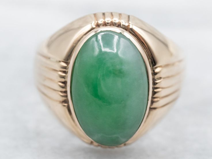 Simple but stylish, this is a classic piece, with a simple structural design. The center stone is subtle, well-polished jade in a domed cabochon cut, bezel set for safety and security. The apple green color is a nice compliment to the warm tone of the gold. Metal: 14K Yellow GoldGem: JadeGem Measurements: 15.1 x 9.9 mm, OvalRing Size: 12Marks: "14K" Stamped on the inside band Modern Green Oval Cabochon Jewelry, Green Oval Dome Ring For Formal Occasions, Formal Green Cabochon Emerald Ring, Elegant Green Dome Ring With Polished Finish, Modern Green Cabochon Jewelry, Modern Oval Green Jewelry, Modern Cabochon Emerald Ring, Green Oval Cabochon Signet Ring For Formal Occasions, Classic Green Oval Cabochon Signet Ring