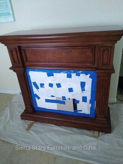 a wooden fireplace with blue and white squares on it