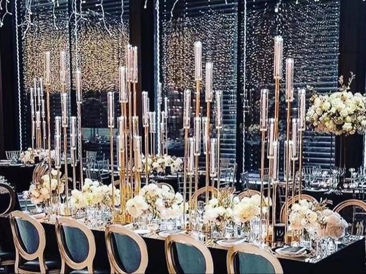 a long table is set up with chairs and centerpieces for an elegant event