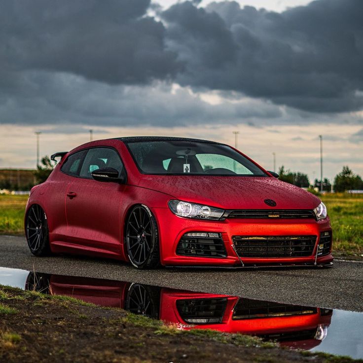 a red car parked on the side of a road