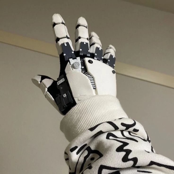 a robot hand wearing a white sweater with black and white designs on it's arm