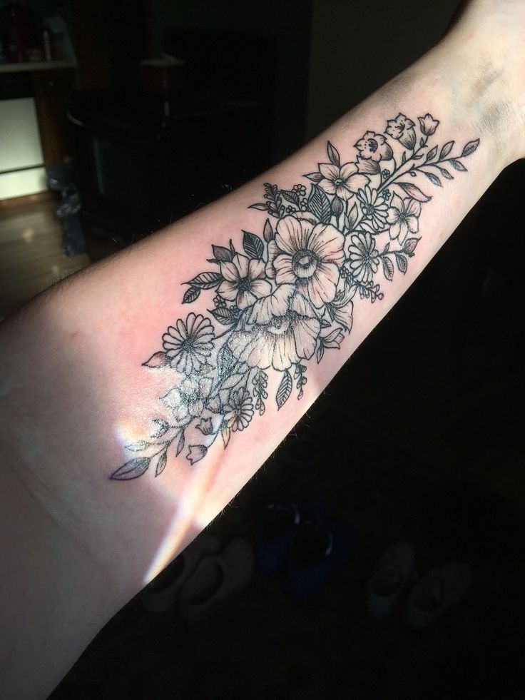 a woman's arm with flowers on it