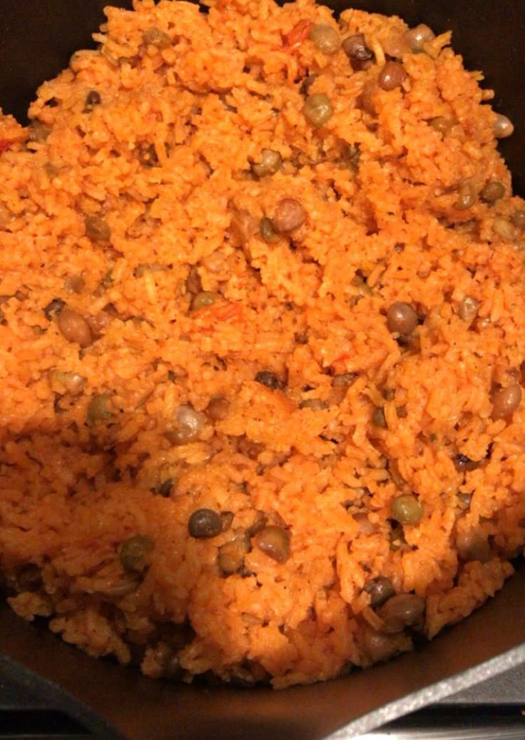 rice and beans are mixed together in a skillet on the stove, ready to be cooked