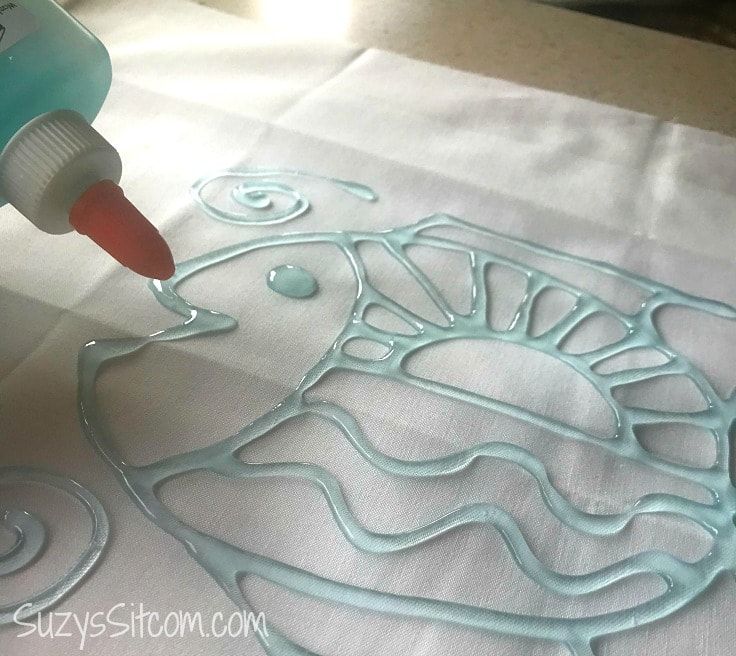 someone is using glue to create an intricate design