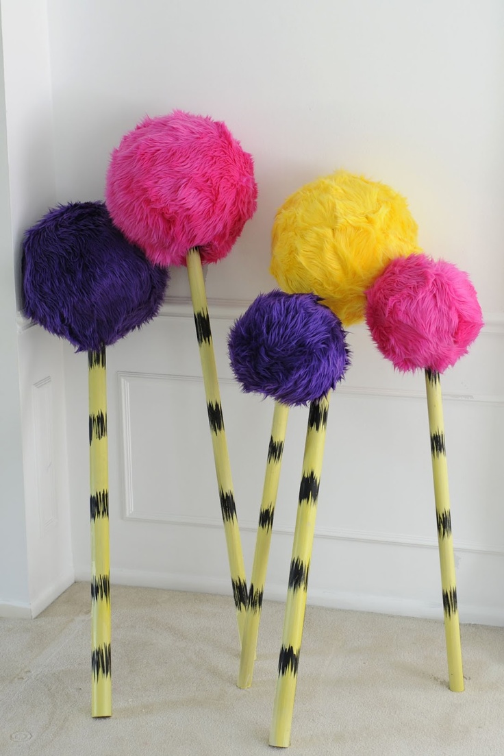 three brightly colored sticks are lined up against the wall