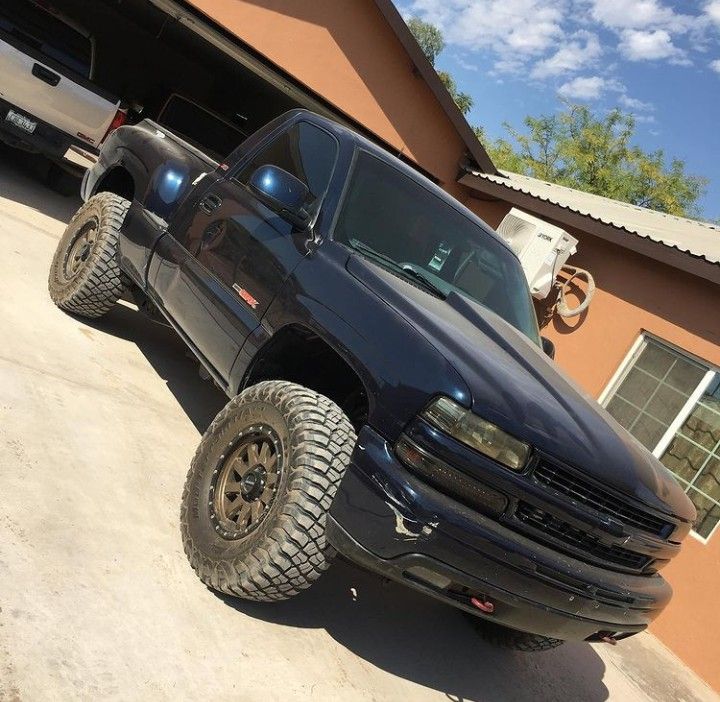 a black truck parked in front of a house