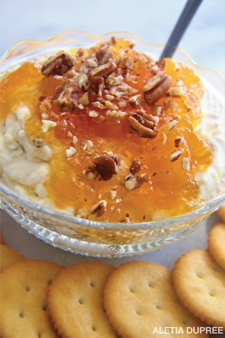 a bowl of food with crackers on the side