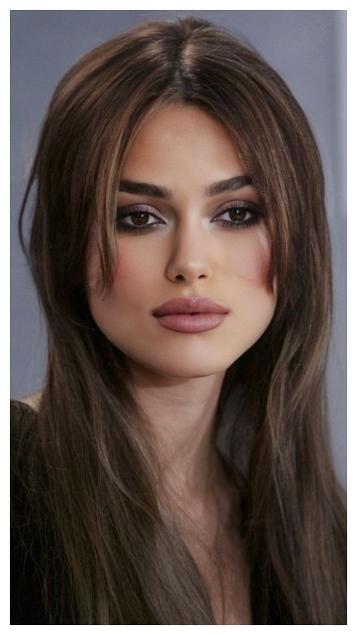 a woman with long brown hair and makeup