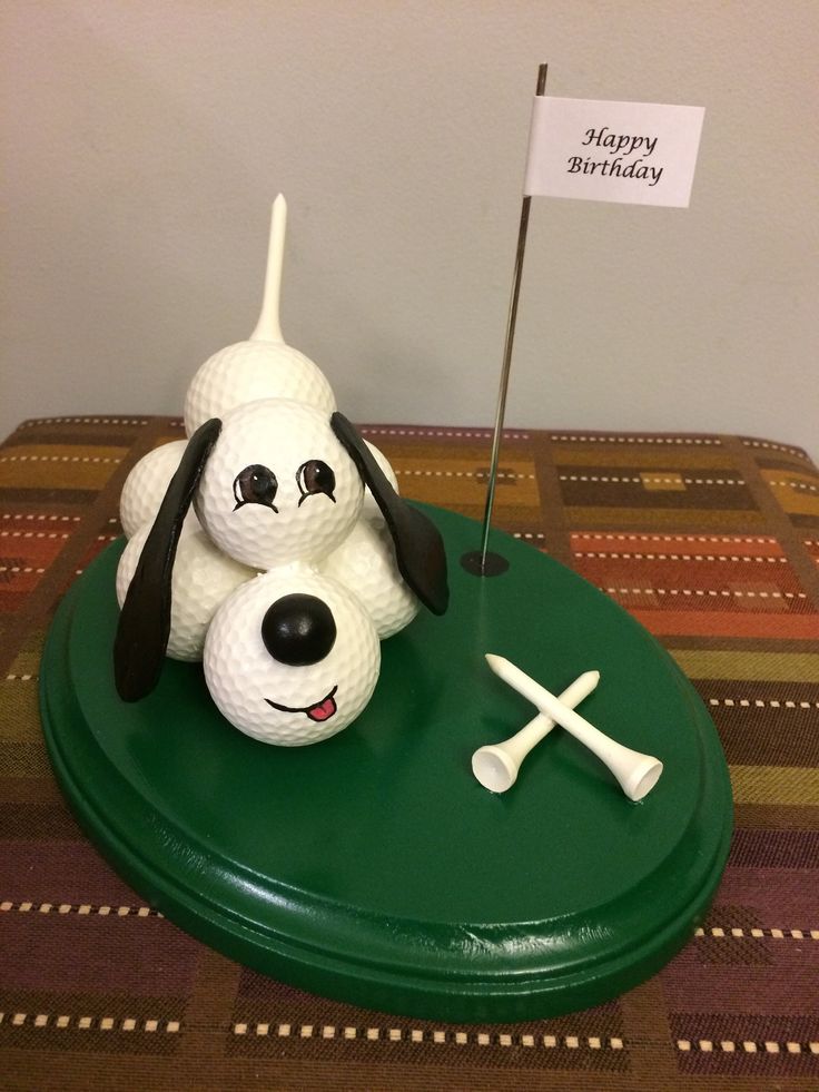 a birthday cake made to look like a golf ball and dog