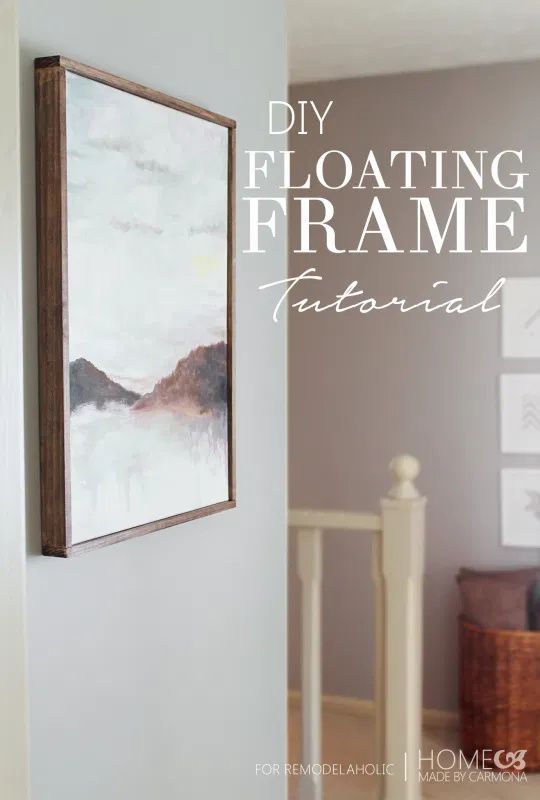 a painting hanging on the wall next to a stair case with text overlay that reads diy floating frame tutorial