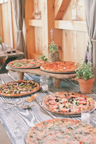 a table topped with lots of pizzas on top of it