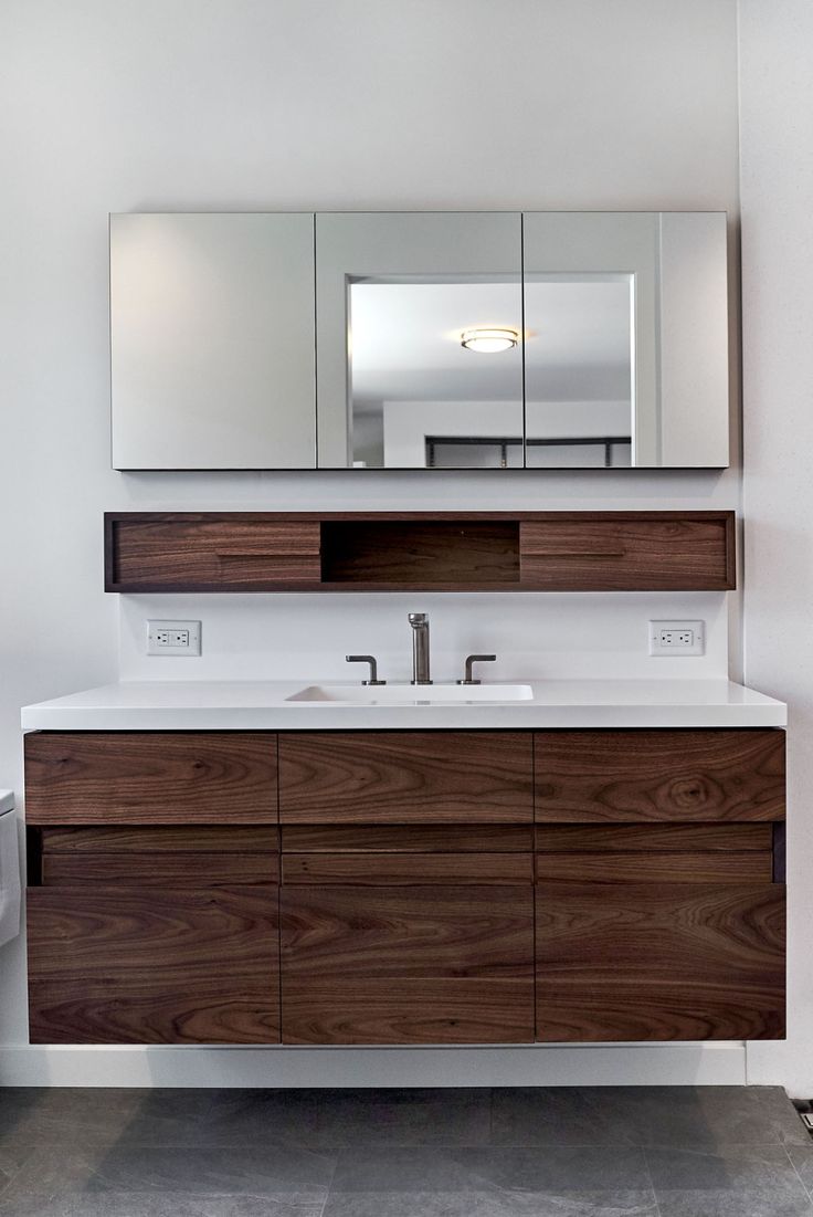 a bathroom vanity with two sinks and mirrors