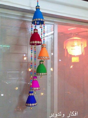 multi colored chandelier hanging from the side of a window