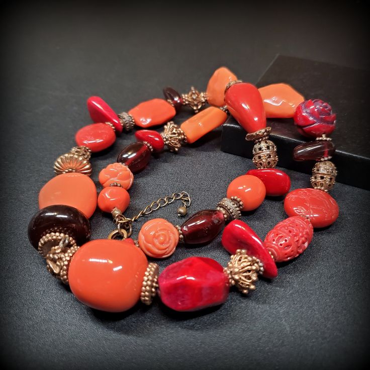 Vintage orange red mix beaded necklace,  24'' long red necklace, Chunky beaded necklace Metal -  gold-tone metal Stone - orange and red mix beads, red coral, glass, porcelain, cinnabar beads 24'' long red necklace, Chunky beaded necklace  Size - 24'' Mark -  Circa the 1960s - 1980s Condition - good condition. PLEASE NOTE: Vintage jewelry can show signs of wear and discoloration or chipped metal consistent with age. Please look at the pictures carefully. Most were purchased at estate sales, aucti Orange Red Coral Beads For Jewelry Making, Orange Red Coral Necklace With Round Beads, Orange Red Coral Beaded Necklaces With Large Beads, Orange Beaded Necklace With Large Red Coral Beads, Orange Red Coral Beaded Necklace With Large Beads, Orange Gemstone Beads Necklace In Red Coral, Unique Orange Red Coral Necklace, Handmade Orange Red Coral Necklace, Orange Red Coral Beaded Necklace For Gift