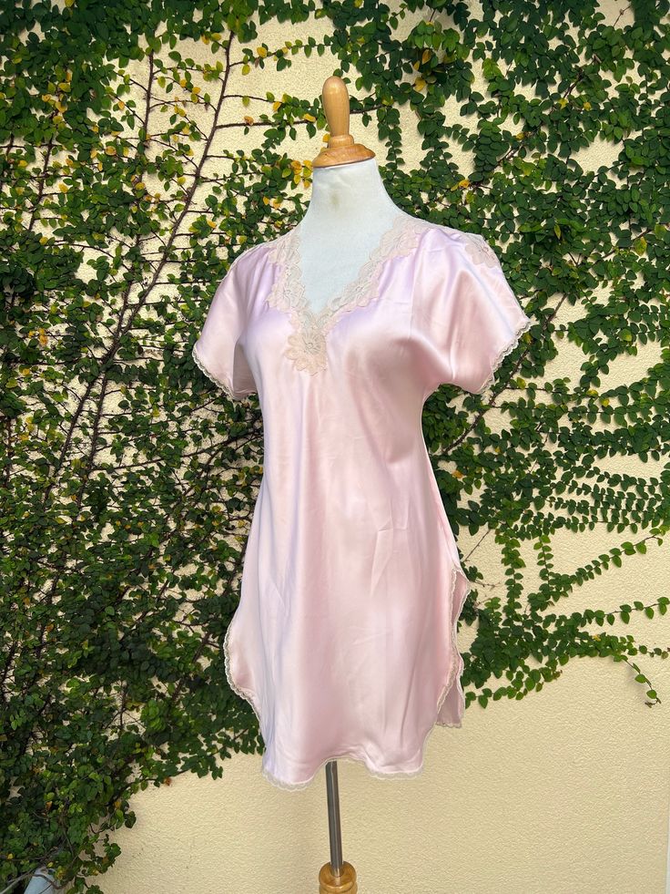 Beautiful Miss Elaine 1960s/70s romantic flowy lingerie robe peignoir. Sheer nylon with floral lace trims on the sleeve and front closure. Front tie closure at the neck. Great vintage condition with some light stains on the sleeve; have not tried to clean. No holes or rips. Size small but very generous in size (see measurements). Gorgeous, classy, timeless piece!  Measurements (flat): Armpit to armpit: 26" Overall length: 51"  Sleeve length: 21" V-neck Lace Trim Robe For Daywear, Feminine V-neck Chemise For Daywear, Feminine V-neck Nightgown With Lace Trim, Feminine V-neck Robe For Sleep, Spring Lace Trim Robe For Bedtime, Pink V-neck Nightgown With Lace Trim, Feminine Pink Sleepwear With Lace Trim, Pink Feminine Sleepwear With Lace Trim, Spring Bedtime Robe With Lace Trim