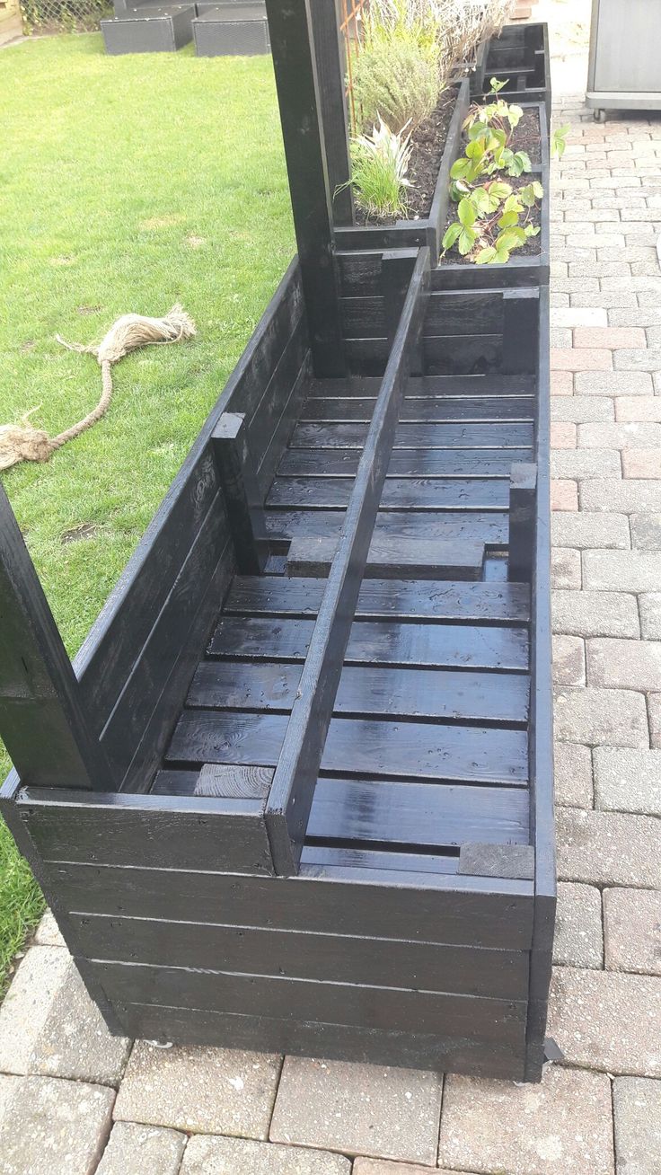 a wooden bench sitting on top of a brick walkway