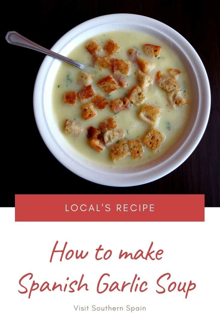 a white bowl filled with soup on top of a wooden table