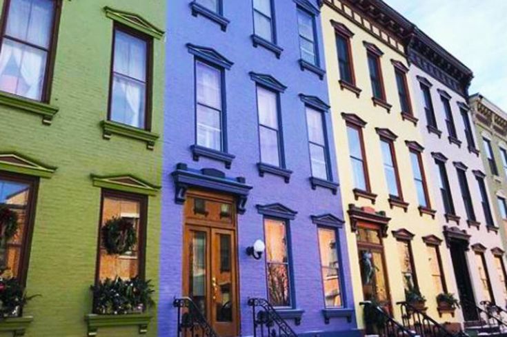 three different colored buildings on the same street