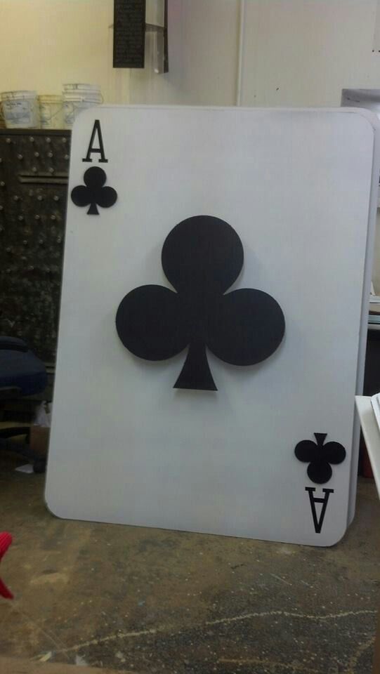 an ace playing card cut out from cardboard and placed on top of a workbench