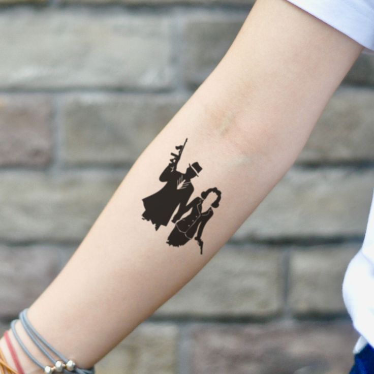 a woman's arm with a tattoo on it that has an image of two people