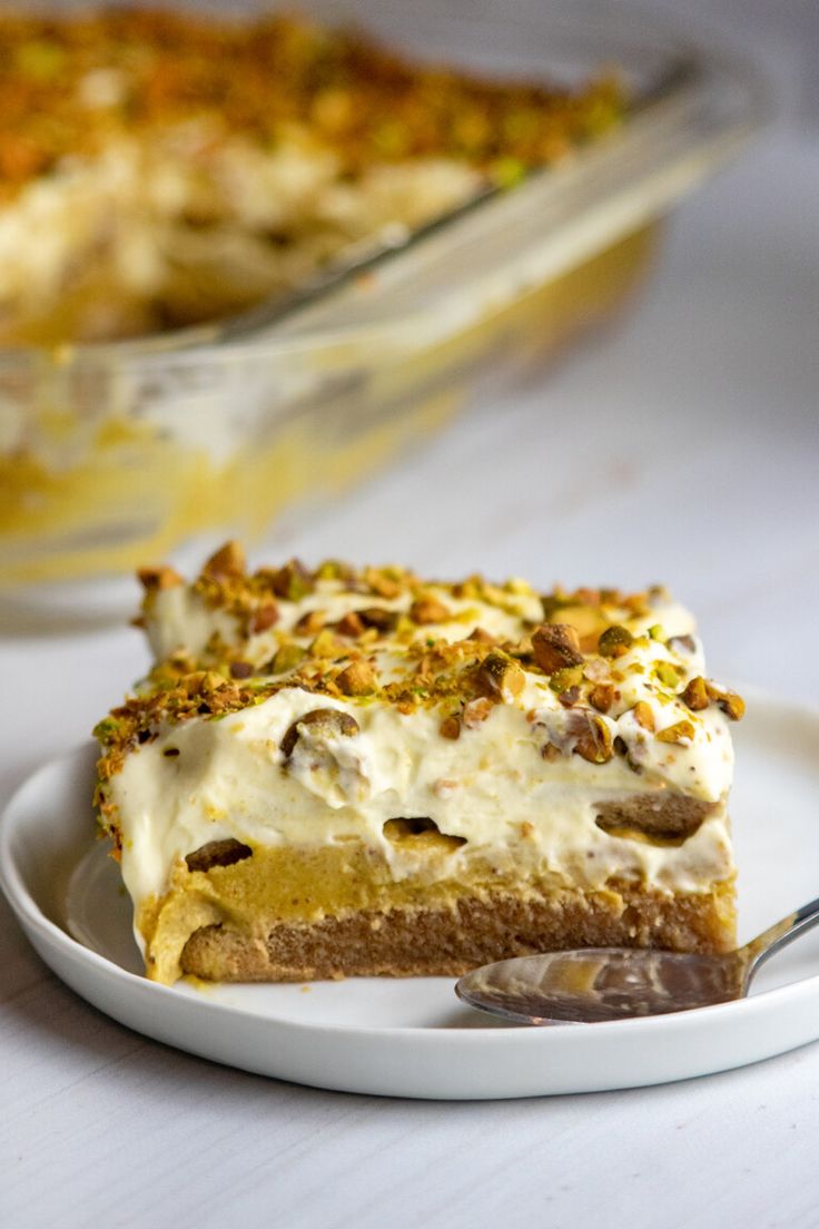 a piece of pie on a plate with a fork in front of it and another dish behind it